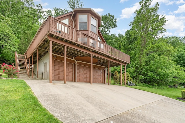 9500 Lower River Rd, Burlington, KY 41005 - view of front of home with a deck, stairs, a garage, and a front yard
