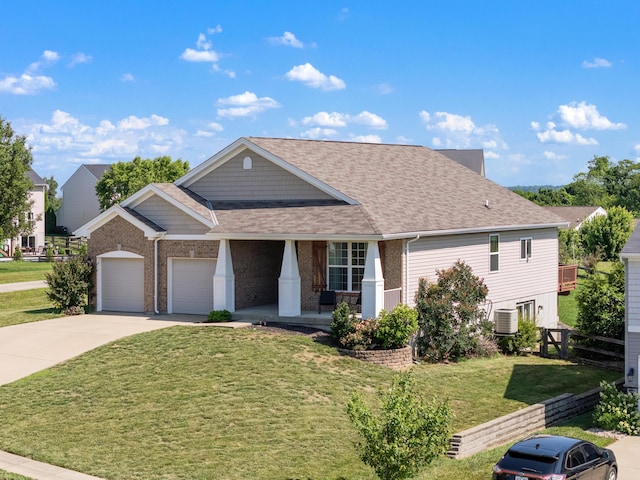 2373 Frontier Dr, Hebron, KY 41048 - craftsman house featuring covered porch, a garage, driveway, brick siding, and roof with shingles