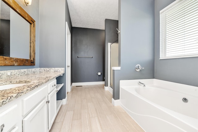 2373 Frontier Dr, Hebron, KY 41048 - bathroom featuring a garden tub, vanity, a stall shower, and wood finished floors