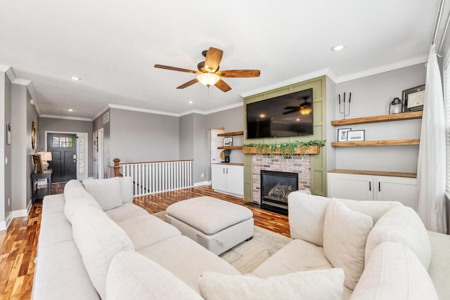 2373 Frontier Dr, Hebron, KY 41048 - living area featuring a ceiling fan, wood finished floors, recessed lighting, crown molding, and a brick fireplace