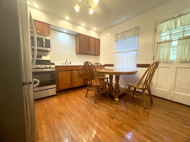 13 Drexel Ave, Florence, KY 41042 - kitchen featuring appliances with stainless steel finishes, brown cabinetry, light wood-style flooring, light countertops, and recessed lighting