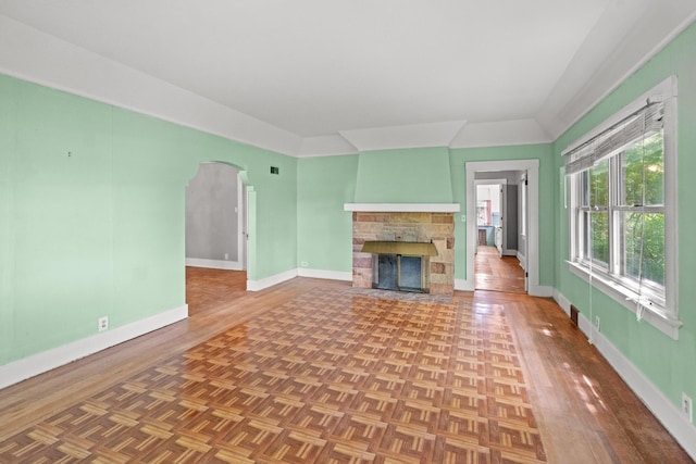 6 Hanover Pl, Fort Thomas, KY 41075 - unfurnished living room with a stone fireplace, arched walkways, and parquet flooring