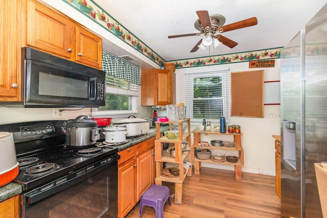 31 Bedinger Ave, Walton, KY 41094 - kitchen with black appliances, ceiling fan, light wood-type flooring, dark countertops, and brown cabinets