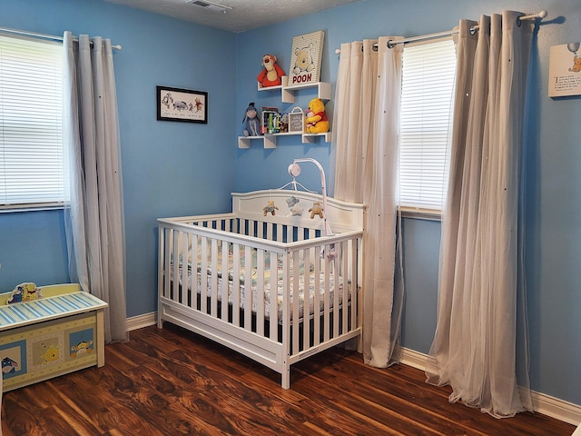 635 Willow St, Elsmere, KY 41018 - bedroom with a nursery area, multiple windows, and wood finished floors