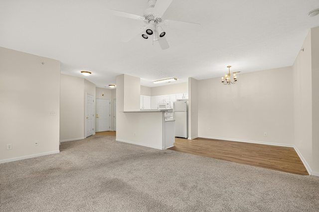 523 Ivy Ridge Dr, Cold Spring, KY 41076 - unfurnished living room with light carpet, a chandelier, and a ceiling fan
