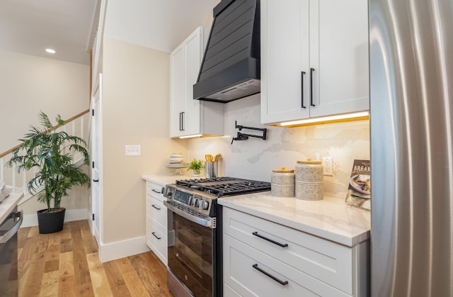 243 Latta Ave, Ludlow, KY 41016 - kitchen featuring extractor fan, appliances with stainless steel finishes, light wood-style flooring, white cabinets, and recessed lighting