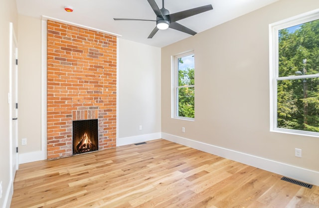 243 Latta Ave, Ludlow, KY 41016 - unfurnished living room featuring light wood-style flooring, a ceiling fan, and a fireplace