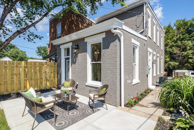 243 Latta Ave, Ludlow, KY 41016 - view of side of property featuring brick siding, a patio area, and outdoor lounge area
