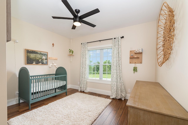 15344 Carlisle Rd, Crittenden, KY 41030 - bedroom featuring dark wood-type flooring, a crib, and a ceiling fan