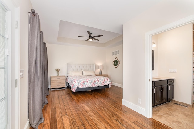 15344 Carlisle Rd, Crittenden, KY 41030 - bedroom with a tray ceiling, light wood-style flooring, a ceiling fan, and ensuite bathroom