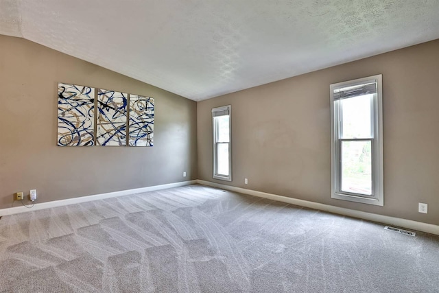 2709 Wesley Dr, Villa Hills, KY 41017 - unfurnished room with vaulted ceiling, carpet flooring, and a textured ceiling