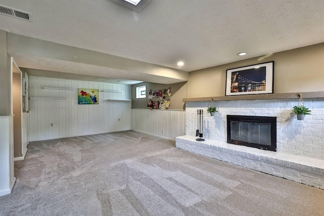 2709 Wesley Dr, Villa Hills, KY 41017 - unfurnished living room featuring a brick fireplace, carpet, a textured ceiling, wainscoting, and recessed lighting