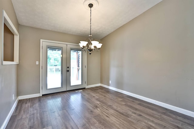 2709 Wesley Dr, Villa Hills, KY 41017 - unfurnished dining area featuring wood finished floors, a chandelier, and french doors