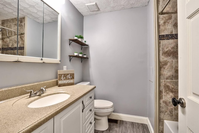 2709 Wesley Dr, Villa Hills, KY 41017 - full bathroom with vanity, a textured ceiling, wood finished floors, and  shower combination
