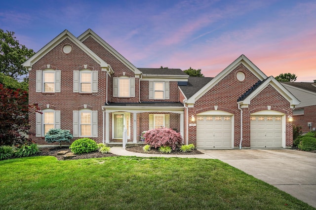 257 Ridgepointe Dr, Cold Spring, KY 41076 - colonial home featuring an attached garage, concrete driveway, brick siding, and a front lawn