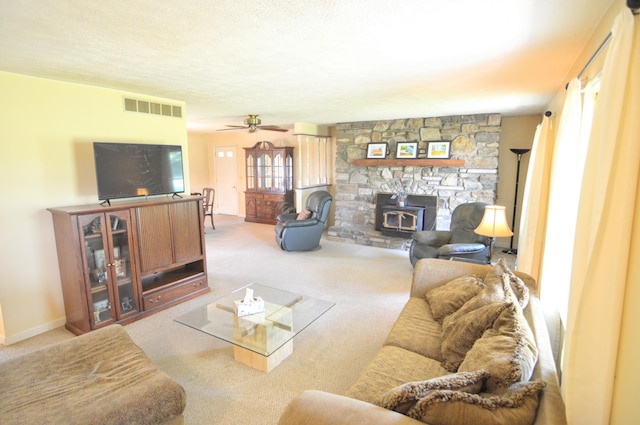 3445 Crittenden Mount Zion Rd, Dry Ridge, KY 41035 - living room featuring carpet floors, a wood stove, a ceiling fan, and a textured ceiling