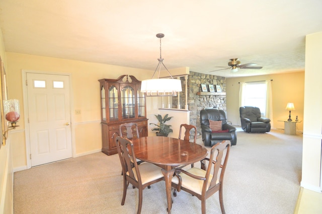 3445 Crittenden Mount Zion Rd, Dry Ridge, KY 41035 - dining space featuring light carpet, ceiling fan, and a stone fireplace