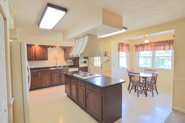 3445 Crittenden Mount Zion Rd, Dry Ridge, KY 41035 - kitchen with white appliances, dark countertops, custom exhaust hood, a kitchen island, and light floors