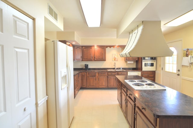 3445 Crittenden Mount Zion Rd, Dry Ridge, KY 41035 - kitchen with white appliances, island exhaust hood, dark countertops, and brown cabinets