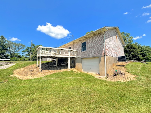 3445 Crittenden Mount Zion Rd, Dry Ridge, KY 41035 - rear view of house featuring a wooden deck, an attached garage, brick siding, and a yard