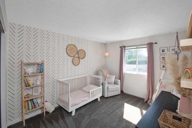 22 Carriage House Dr, Fort Thomas, KY 41075 - bedroom with an accent wall, wallpapered walls, dark carpet, a crib, and a textured ceiling