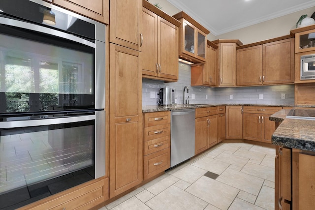 1025 Hyperion Ct, Union, KY 41091 - kitchen featuring stainless steel appliances, backsplash, crown molding, dark stone counters, and glass insert cabinets