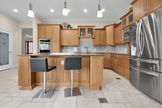 1025 Hyperion Ct, Union, KY 41091 - kitchen featuring appliances with stainless steel finishes, ornamental molding, backsplash, a center island with sink, and brown cabinetry