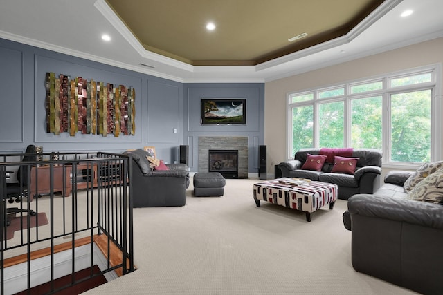1025 Hyperion Ct, Union, KY 41091 - carpeted living area with crown molding, a tray ceiling, a stone fireplace, and a decorative wall