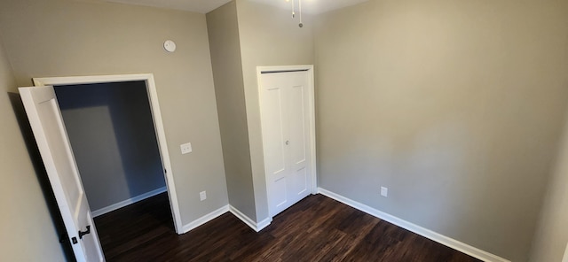 122 E 13th St, Covington, KY 41011 - unfurnished bedroom featuring dark wood-style flooring and baseboards