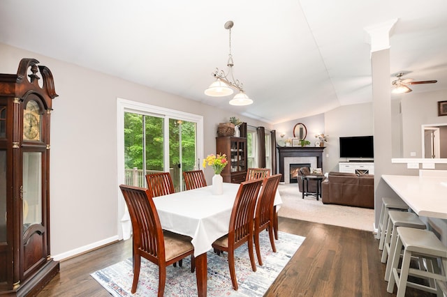 10234 Hempsteade Dr, Union, KY 41091 - dining room featuring lofted ceiling, dark wood-style flooring, a lit fireplace, and ceiling fan