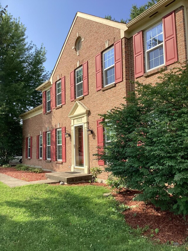 1033 Macintosh Ln, Florence, KY 41042 - colonial inspired home featuring brick siding and a front lawn