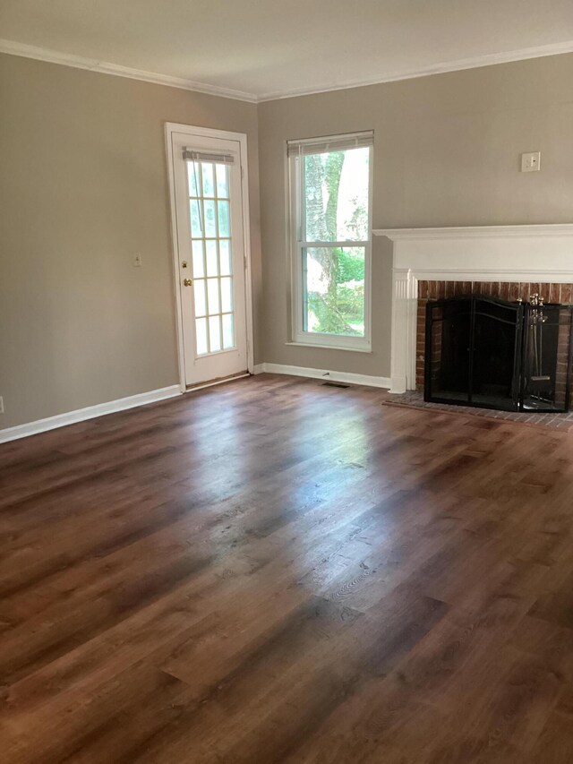 1033 Macintosh Ln, Florence, KY 41042 - unfurnished living room featuring crown molding, a fireplace, and dark wood-style floors