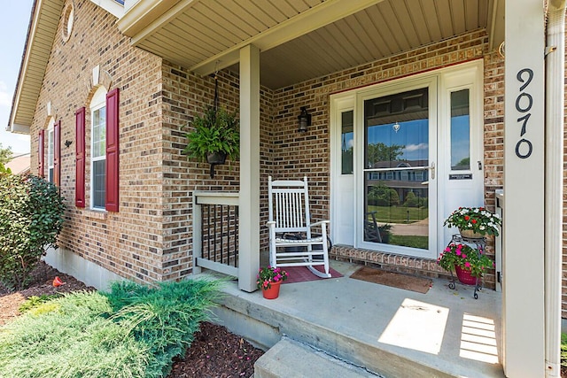 9070 Braxton Dr, Union, KY 41091 - view of exterior entry with brick siding and a porch