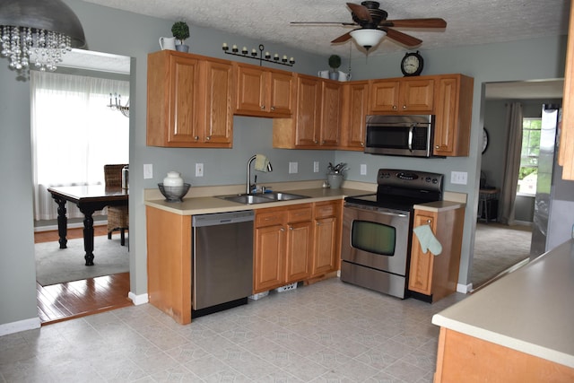 6596 Elgin Ct, Burlington, KY 41005 - kitchen with appliances with stainless steel finishes, a ceiling fan, a chandelier, light countertops, and a textured ceiling
