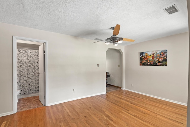 1468 N Bend Rd, Hebron, KY 41048 - spare room featuring a ceiling fan, light wood finished floors, arched walkways, and a textured ceiling