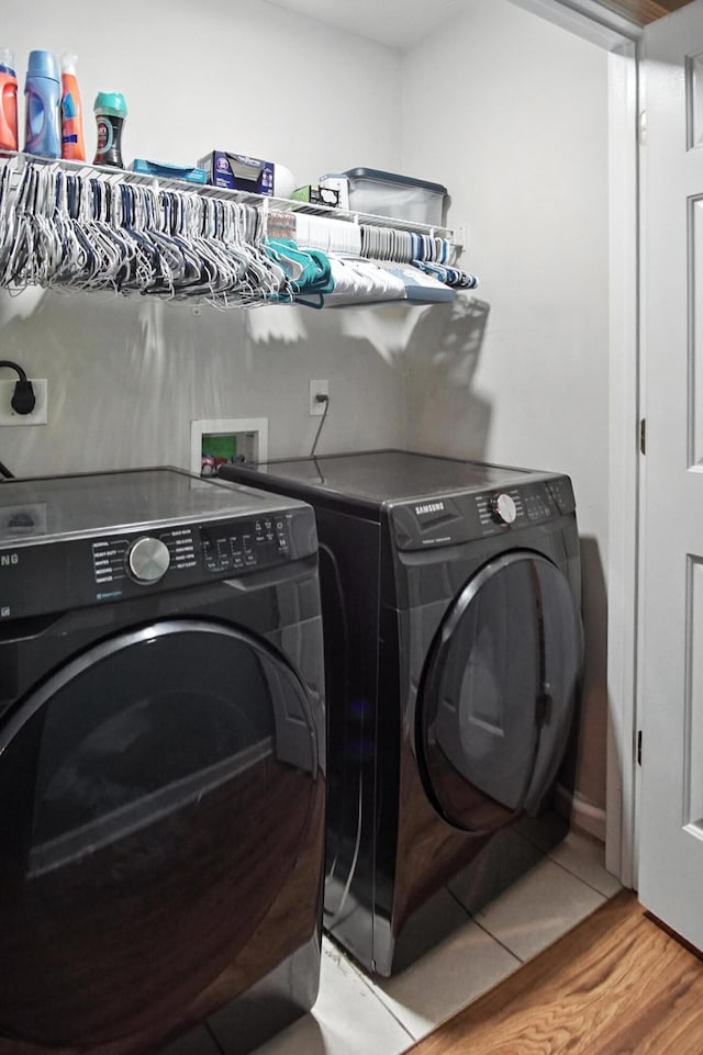 10239 Knob Hill Dr, Florence, KY 41042 - laundry room with washing machine and dryer and wood finished floors