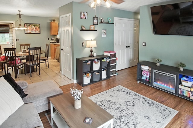 10239 Knob Hill Dr, Florence, KY 41042 - living area featuring ceiling fan, wood finished floors, and a chandelier
