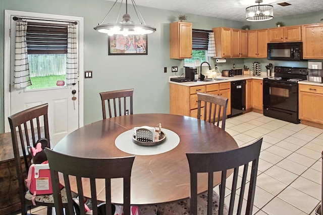 10239 Knob Hill Dr, Florence, KY 41042 - kitchen with black appliances, a chandelier, light tile patterned floors, and light countertops