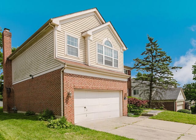 3310 Kingsburg Ct, Erlanger, KY 41018 - view of front of house with an attached garage, brick siding, driveway, a front yard, and a chimney