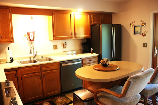 6065 Tosha Dr, Burlington, KY 41005 - kitchen with stainless steel dishwasher, freestanding refrigerator, a breakfast bar, light countertops, and a kitchen island