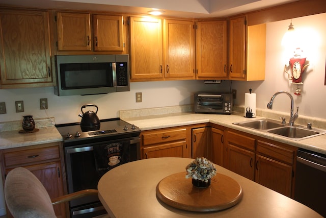 6065 Tosha Dr, Burlington, KY 41005 - kitchen with stainless steel appliances, light countertops, and brown cabinets