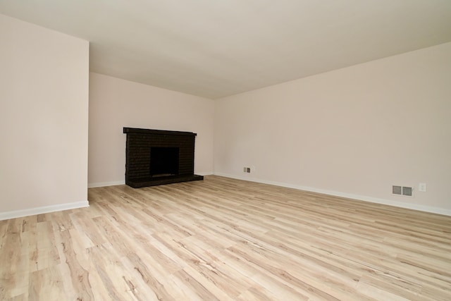 680 Manor Dr, Taylor Mill, KY 41015 - unfurnished living room with light wood finished floors and a brick fireplace