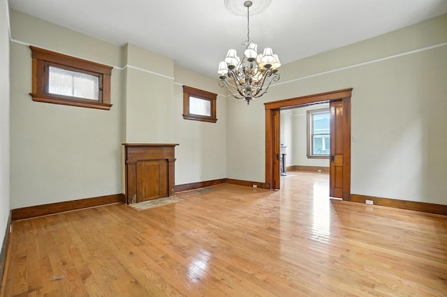 234 Walnut St, Bellevue, KY 41073 - empty room featuring a chandelier and light wood-style flooring