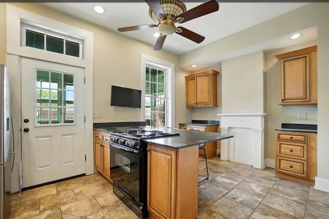 234 Walnut St, Bellevue, KY 41073 - kitchen with black gas range, dark countertops, a breakfast bar, brown cabinetry, and a peninsula