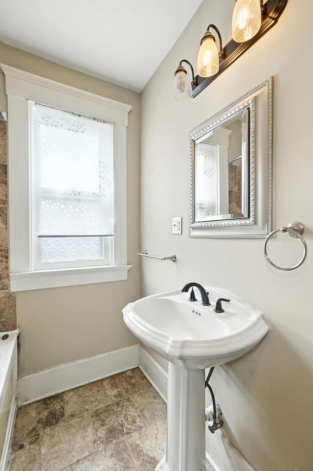 234 Walnut St, Bellevue, KY 41073 - bathroom featuring a tub to relax in and stone finish floors