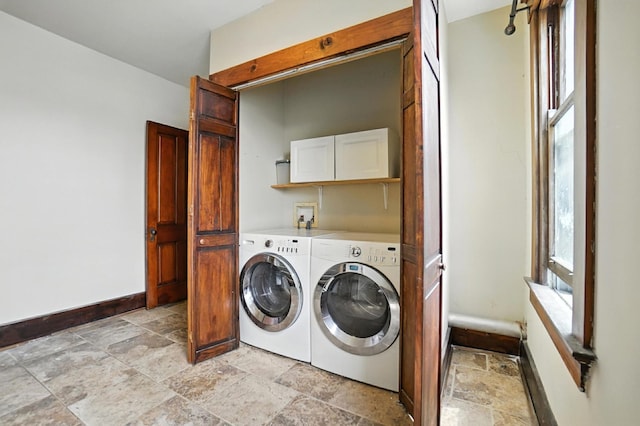234 Walnut St, Bellevue, KY 41073 - laundry area with stone tile flooring, washer and dryer, plenty of natural light, and cabinet space