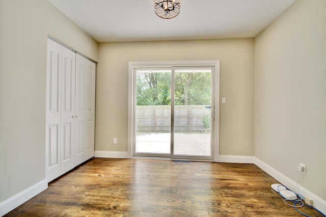 693 Peach Tree Ln, Erlanger, KY 41018 - unfurnished bedroom with access to exterior, wood finished floors, and a closet