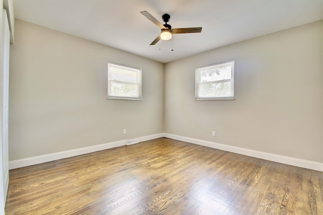 693 Peach Tree Ln, Erlanger, KY 41018 - unfurnished room featuring plenty of natural light, a ceiling fan, and wood finished floors