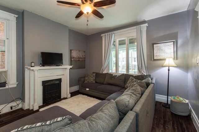 332 W 21st St, Covington, KY 41014 - living area with ceiling fan, dark wood-style flooring, and a fireplace