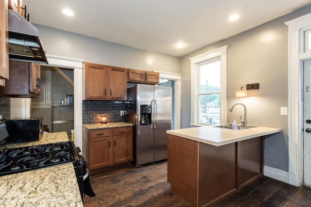332 W 21st St, Covington, KY 41014 - kitchen with stainless steel fridge, range hood, black gas range, dark wood-style flooring, and backsplash
